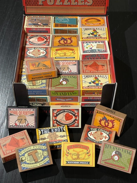 Conundrum House - Professor Puzzle Matchbox Puzzles - Display of all 15 varieties.
